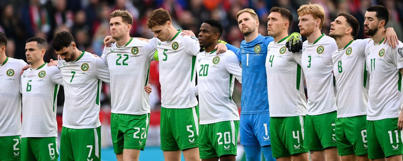 Two teams of soccer players standing together on a field